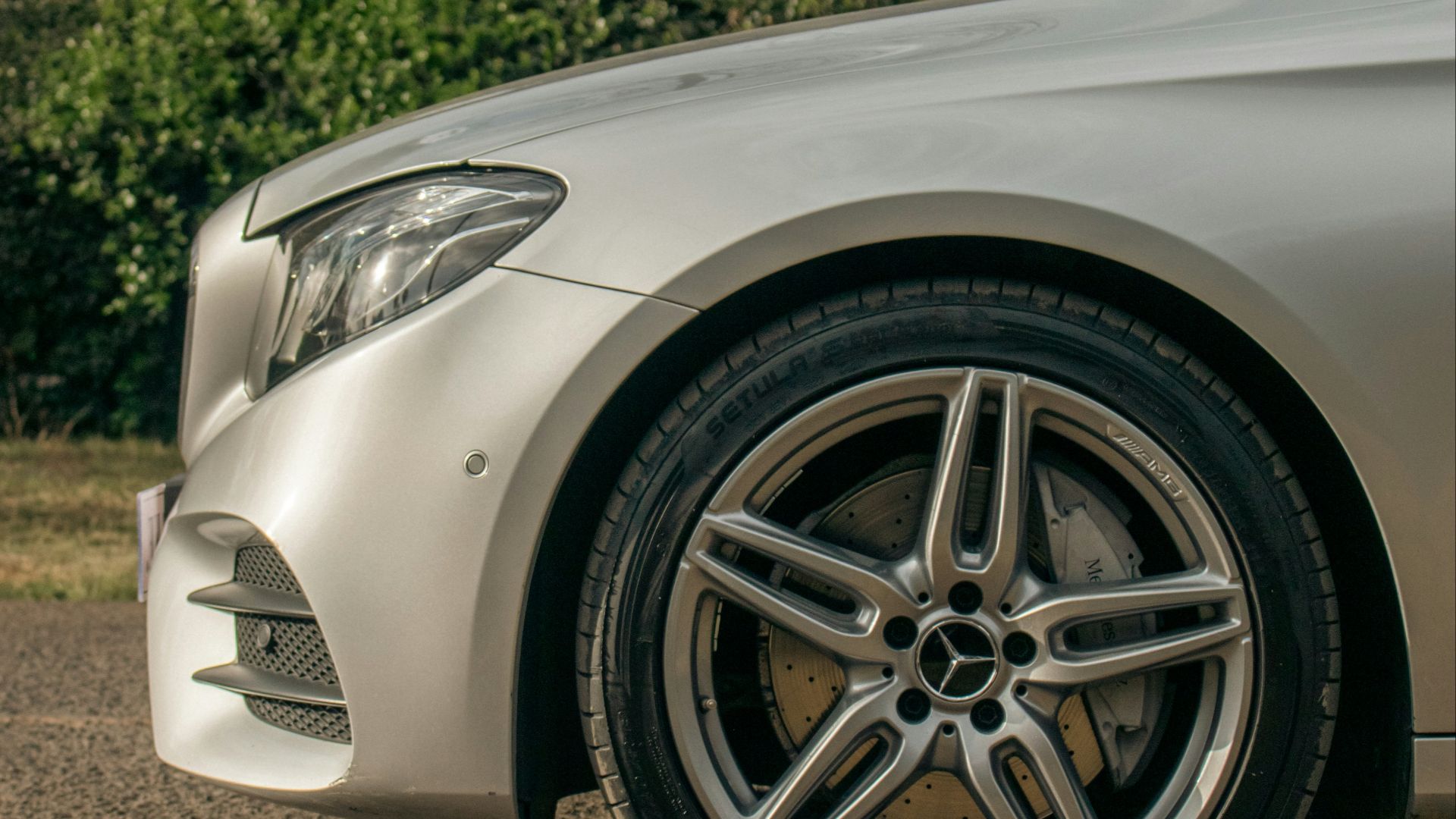 a white car parked on gravel